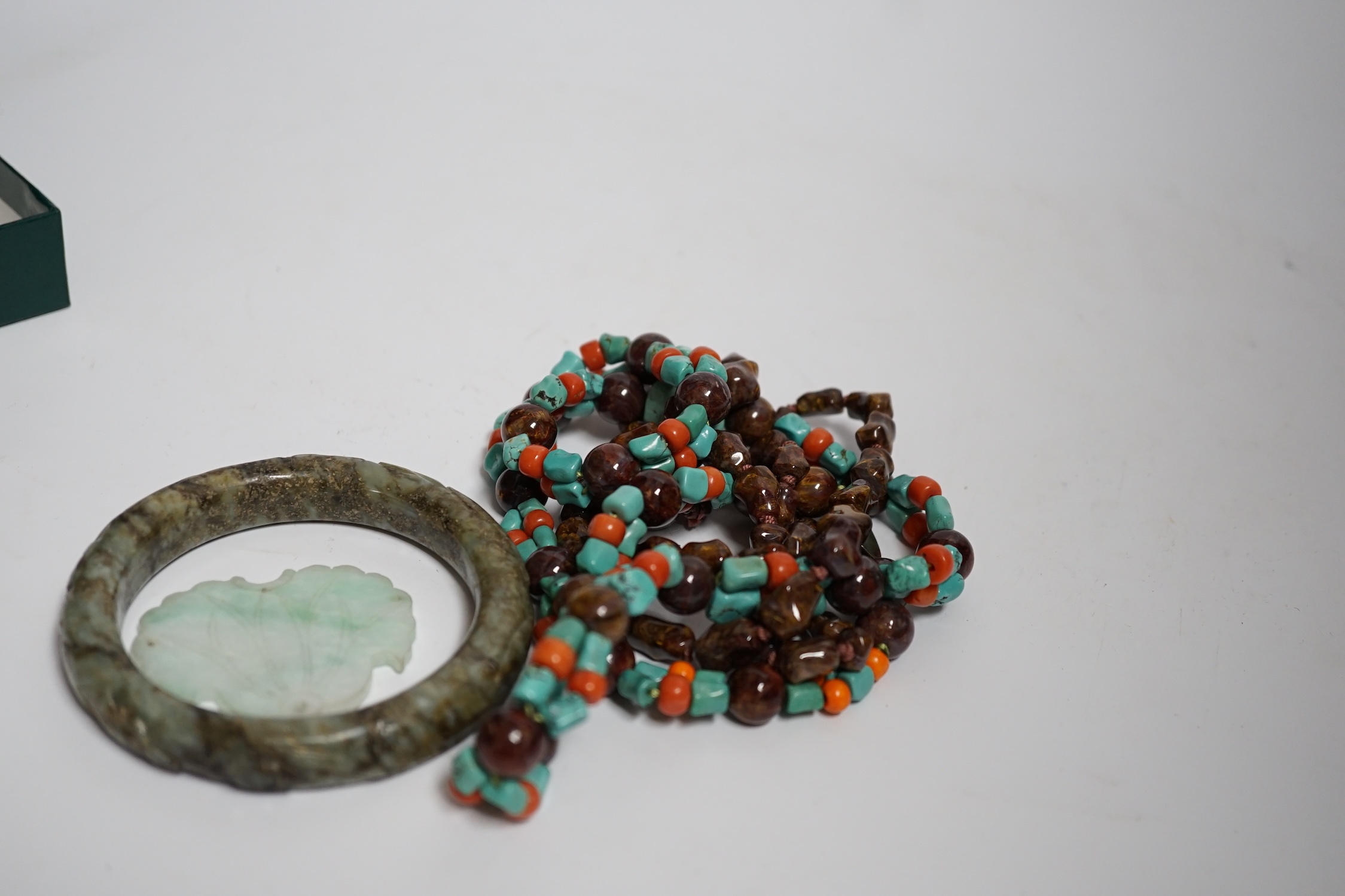 Two Chinese hardstone necklaces, a carved bangle and a jade carving, bangle 8.5cm in diameter
